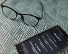 Смартфон с запущенным приложением ChatGPT, расположенный рядом с очками на поверхности с узором