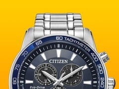 Крупный план часов Citizen BL5640-59L с циферблатом глубокого синего цвета на фоне однотонного желтого цвета.