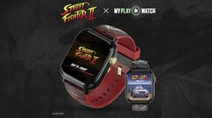 Игровые часы Street Fighter II: My Play Watch с красным ремешком, деталями с золотистым покрытием и вторым часовым дисплеем на тёмном текстурированном фоне.