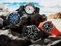 Четыре дайверские часы Citizen Promaster Marine в белом, чёрном, синем и оранжевом цветах, выставленные на камнях у берега моря.