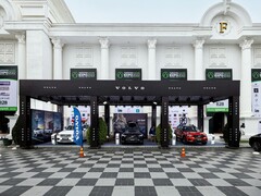 Выставочный стенд Volvo на Realestate.com.kh Expo 2022, демонстрирующий множество автомобилей Volvo, включая внедорожники, с рекламными баннерами и брендингом на фоне величественного белого здания с колоннами. (Источник изображения: I'm Zion via Pexels)