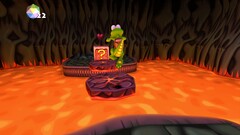 Скриншот Croc Legend of Gobbos показывает, как Крок прыгает через лаву