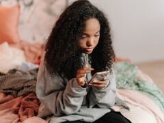 Подросток со смартфоном на кровати, символическое изображение для ChatGPT for Teens и родительского контроля