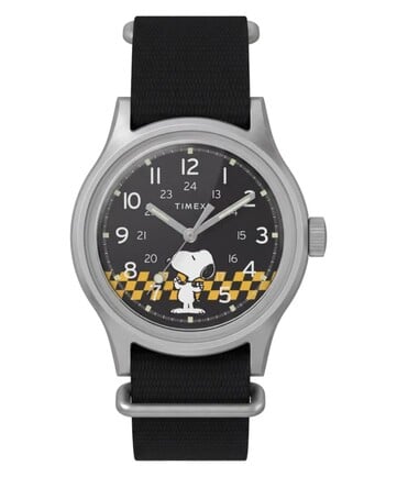 Вид спереди модели Peanuts x Timex MK1, на котором видны чёрный циферблат, арабские цифры, светящиеся стрелки и метки, а также рисунок Снупи в клетку.