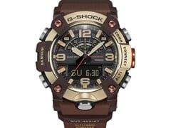 Крупный план часов G-Shock Mudmaster GG-B100XMH-5A, демонстрирующий их корпус и безель светло-желто-золотого и коричневого цветов.