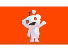 Рекламное изображение талисмана Reddit, Сну, машущего зрителю и позирующего на красном фоне. (Источник изображения: Reddit)